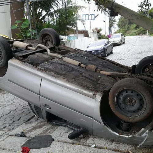 Com as rodas para cima: carro capota, derruba poste e deixa dois feridos em Arraial do Cabo